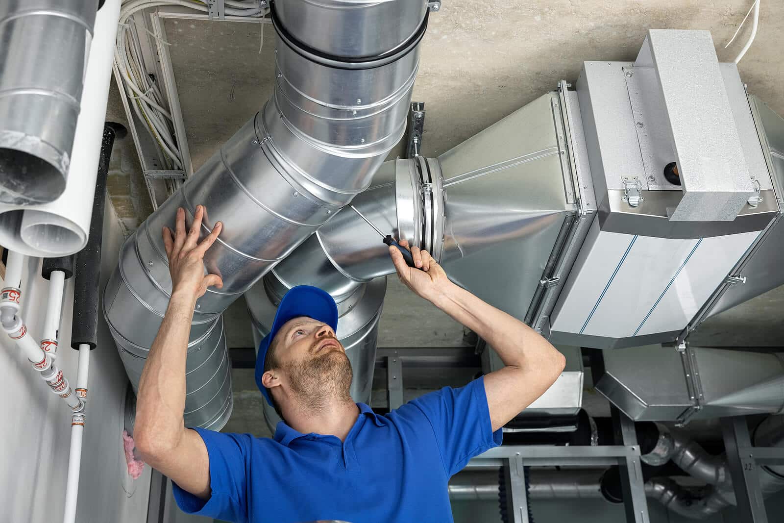 HVAC technician inspecting and repairing air ducts in Inglewood