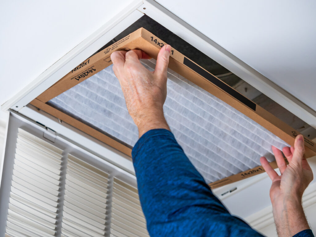 HVAC technician replacing a home air filter in Inglewood