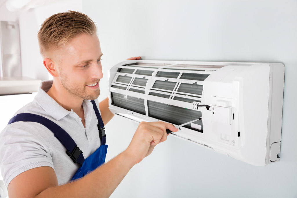 HVAC technician maintaining a ductless air conditioner in Inglewood