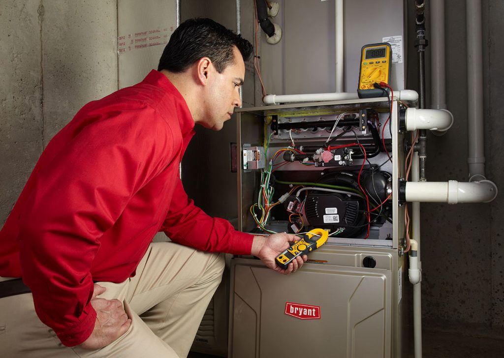 Heating technician diagnosing a furnace repair in Inglewood