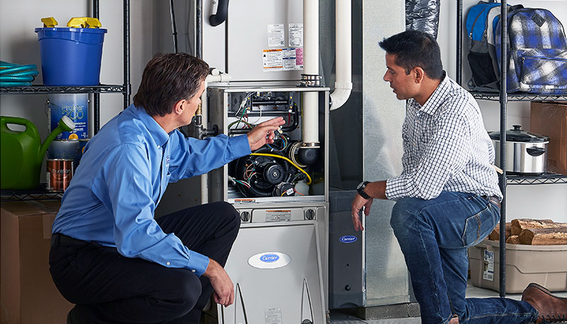Technician evaluating a furnace for repair or replacement in Inglewood