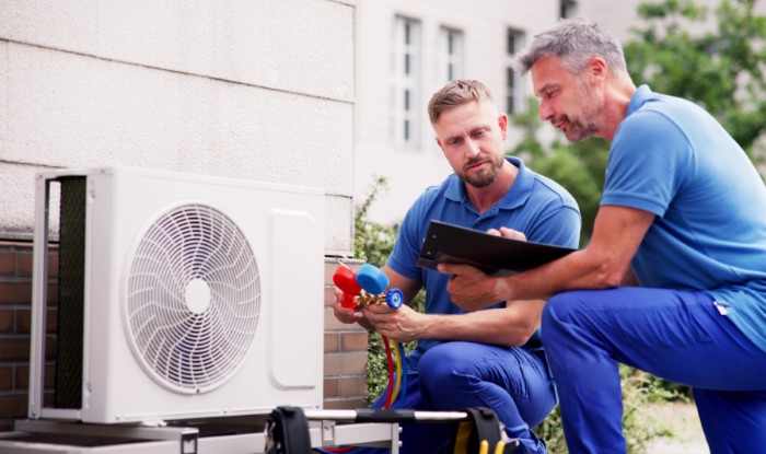 HVAC technicians installing an outdoor air conditioning unit in Inglewood