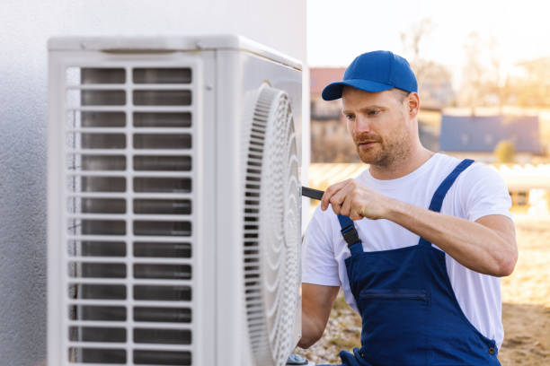 HVAC technician servicing an outdoor air conditioner in Inglewood