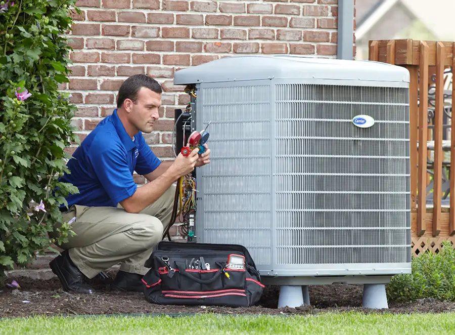 HVAC technician inspecting an outdoor AC unit in Inglewood